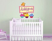 Cupcakes holding sign with giraffe behind